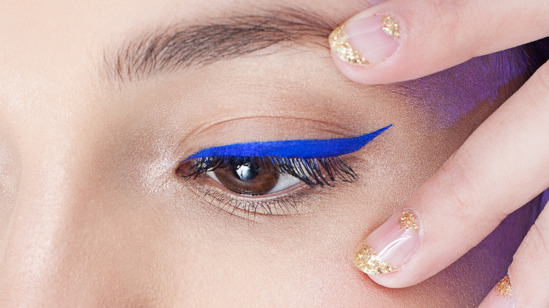 brown-eyed person wearing blue eyeliner