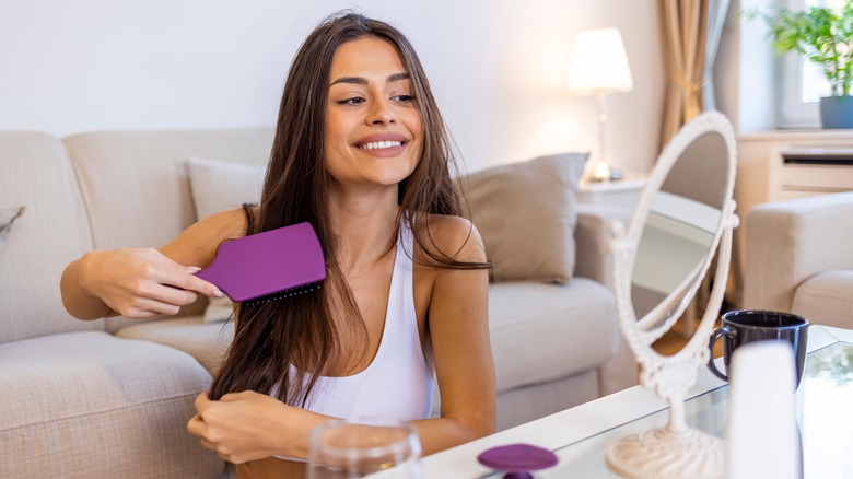 Woman brushing straight hair