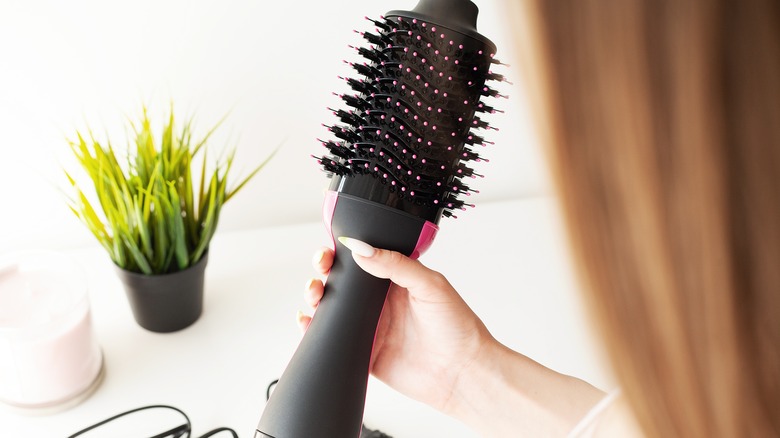 Hand holding thermal brush