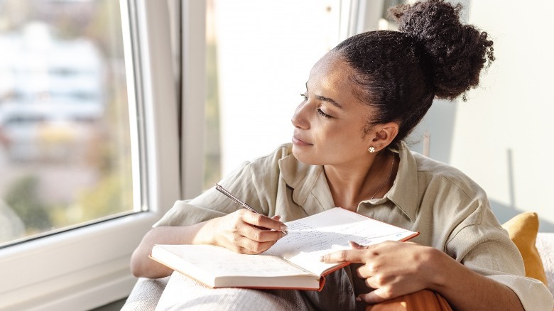 Woman writing in journal