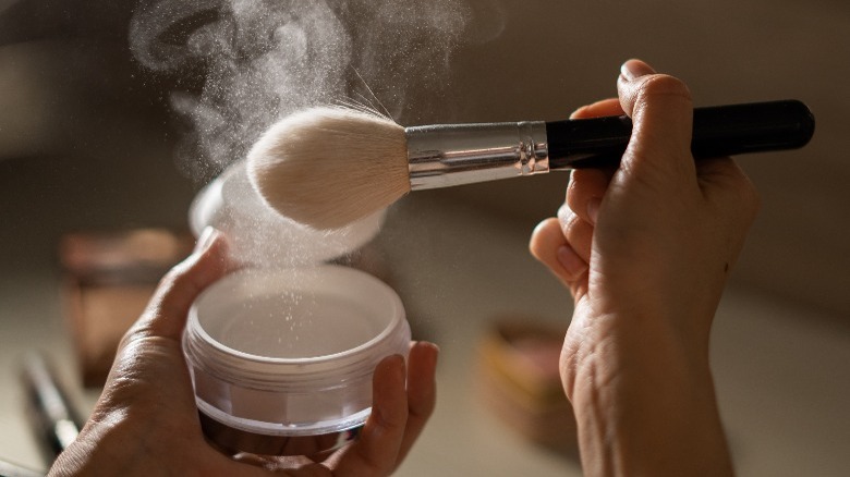 Brush picking up powder makeup