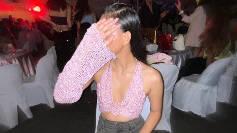 woman wearing crochet butterfly top