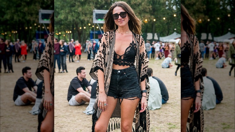 Woman poses in printed caftan with fringe