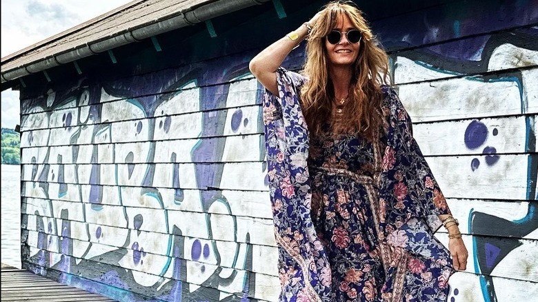 Woman poses in floral caftan