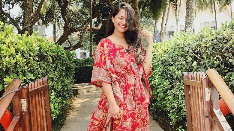 Woman poses in red caftan 