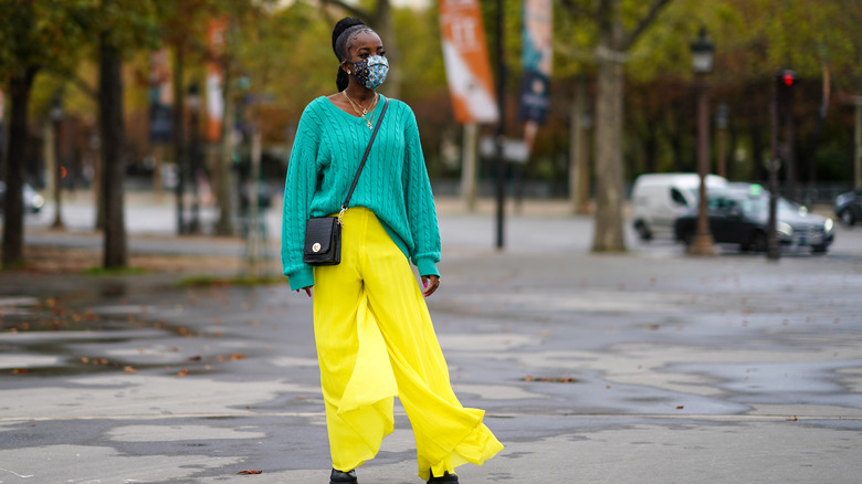 woman wearing aqua cable-knit sweater