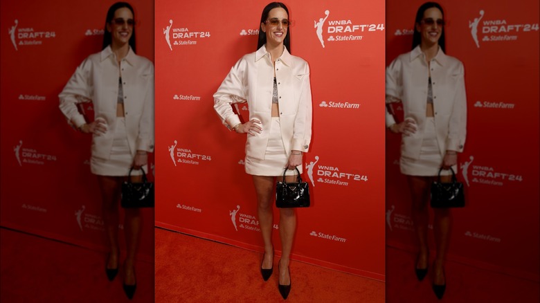 Caitlin Clark white prada outfit black handbag