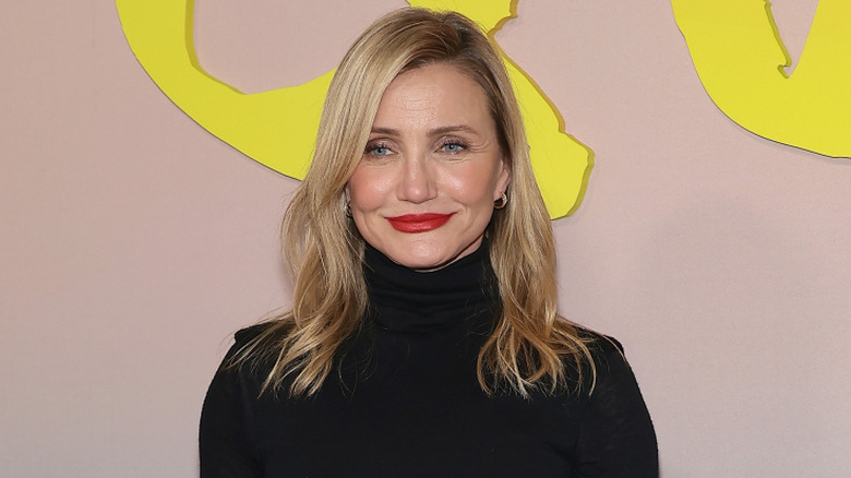Cameron Diaz wearing a black turtleneck with red lipstick