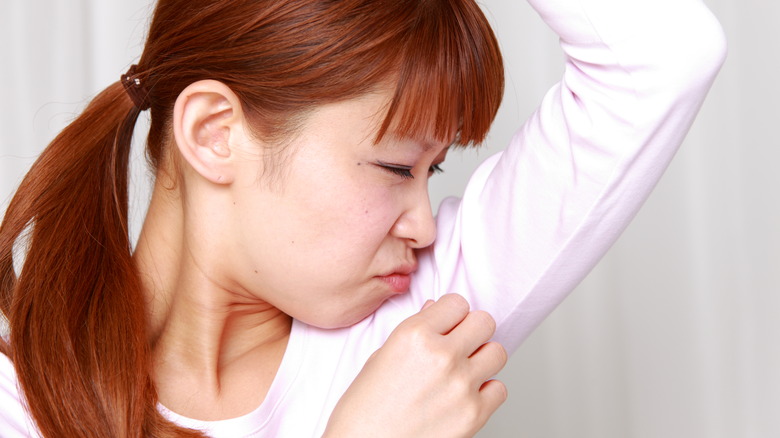 woman sniffing armpit