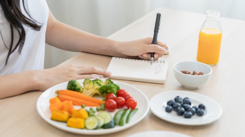 Woman with almonds and vegetables