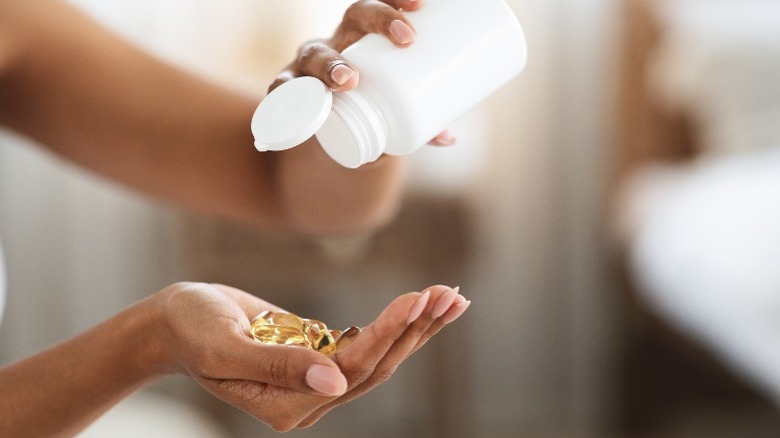 Pouring pills into a hand