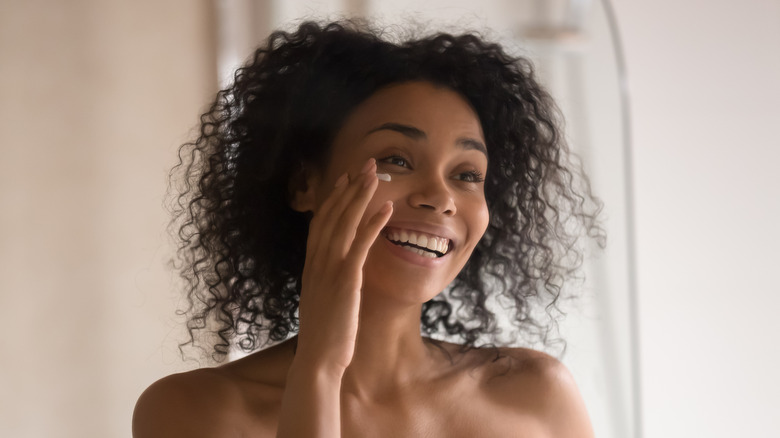 Woman applying under-eye cream