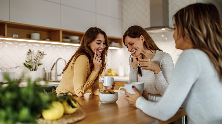 Three women chatting over coffee