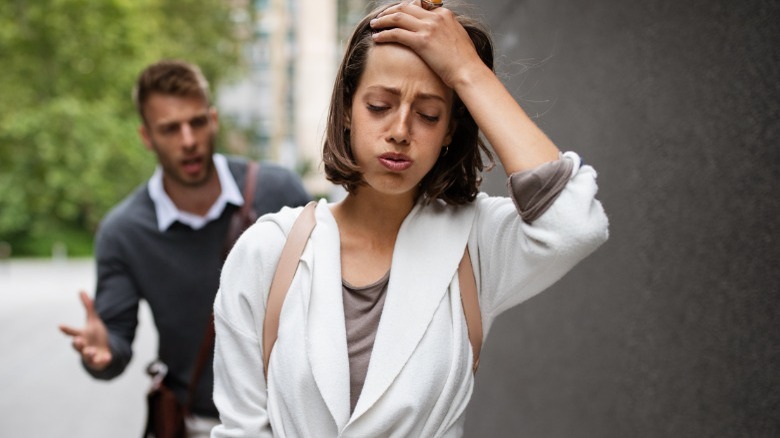 Sad woman walking by man