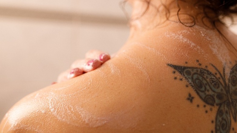 Person with a tattoo in the shower