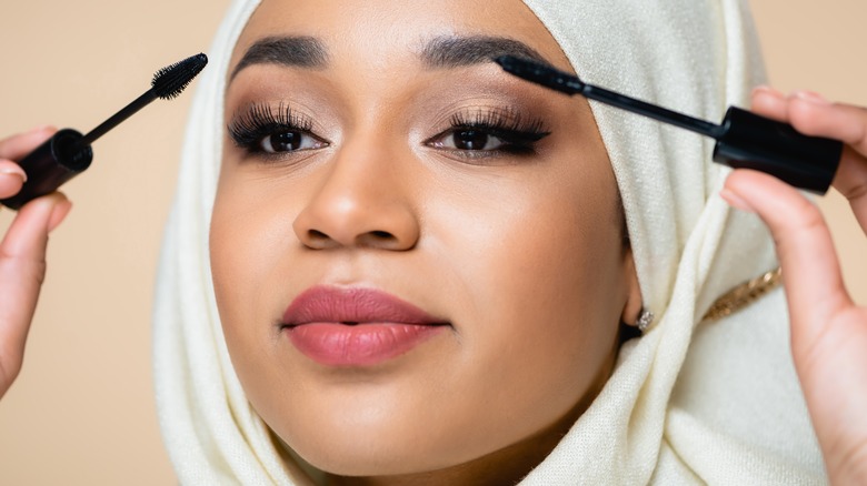 woman applying mascara