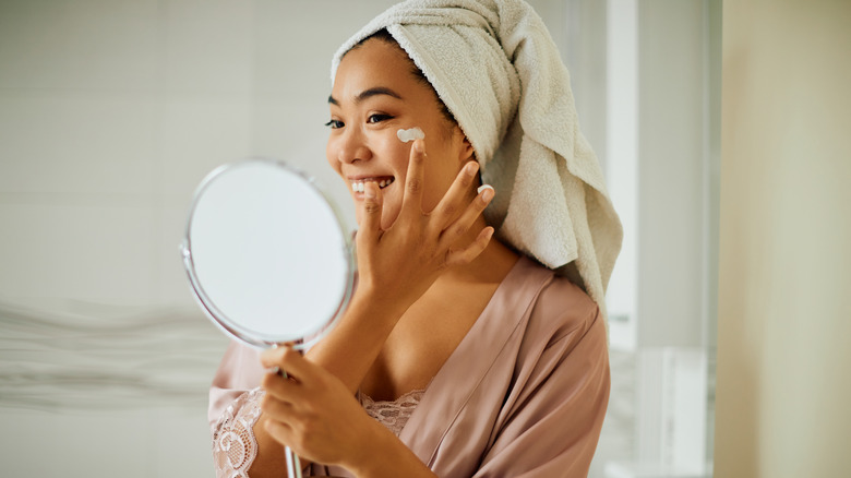 woman applying skincare product