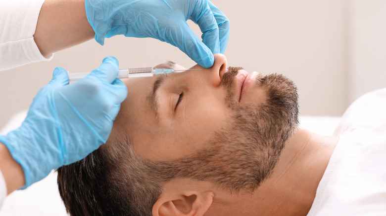 Model undergoing nonsurgical rhinoplasty