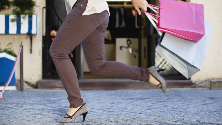 Woman running with shopping bags