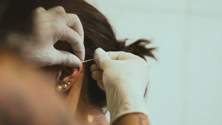 Piercing ear with multiple earrings