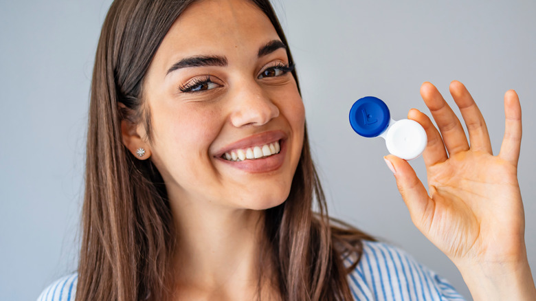 female holding lense case