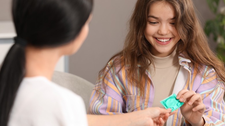 Woman giving a condom