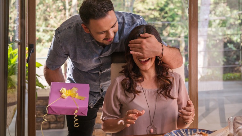 Man surprising wife with gift