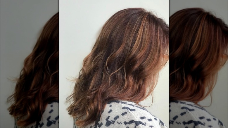 Copper candle lights on woman