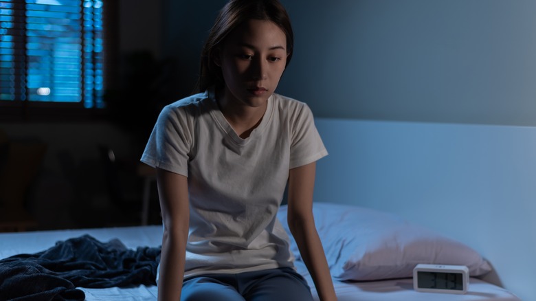 woman sitting on a bed