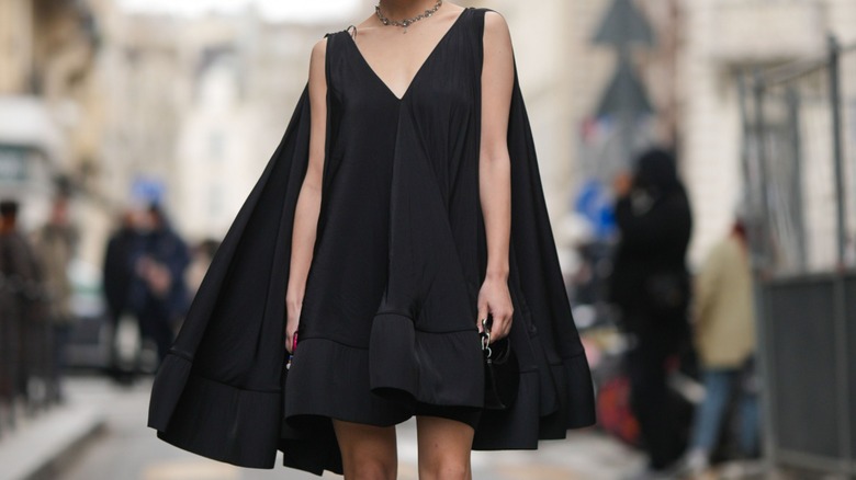 woman wearing black cape dress