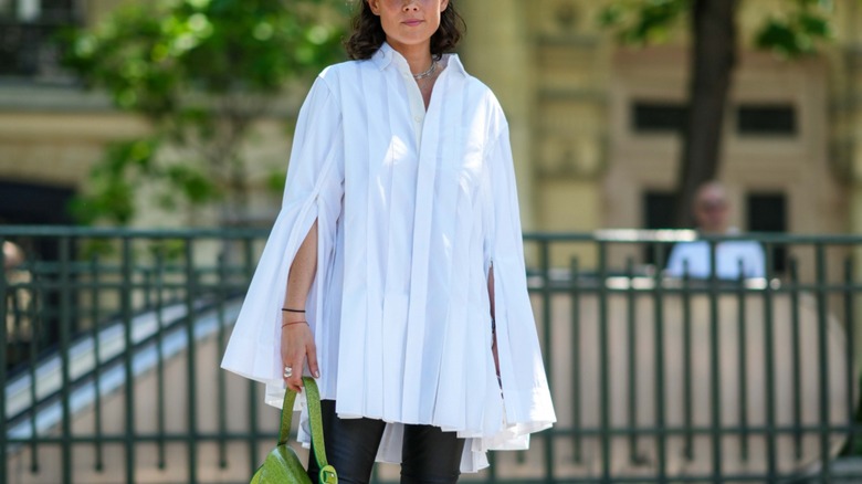 woman wearing cape top