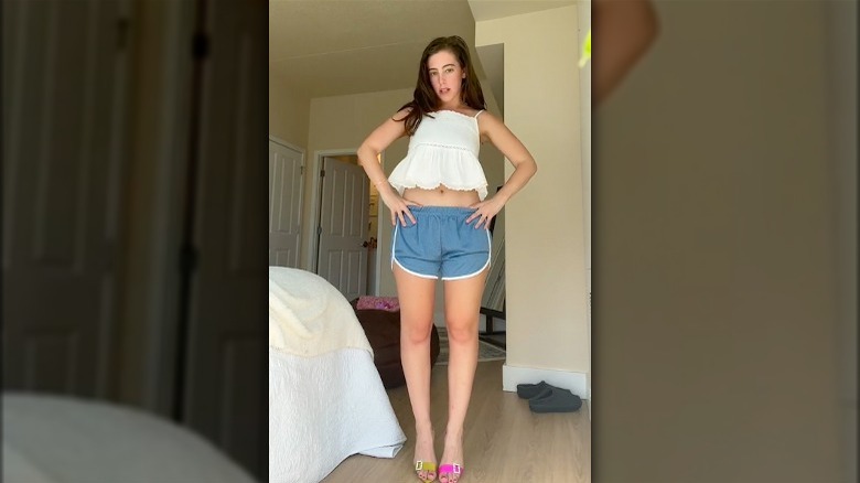 Girl in green blouse and white shorts