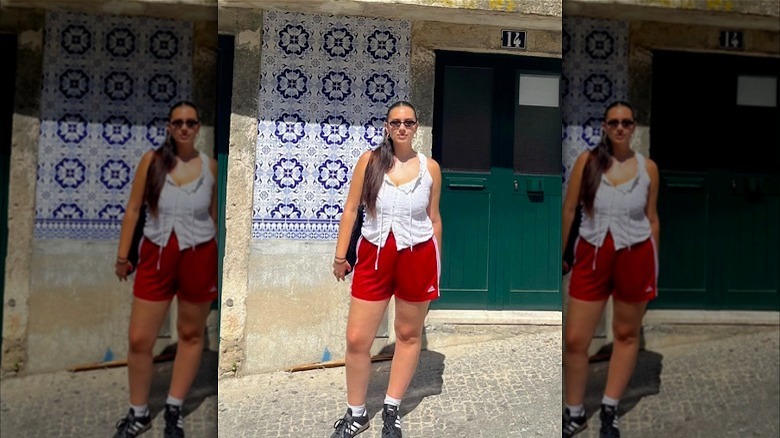Girl wearing white blouse and colorful shorts