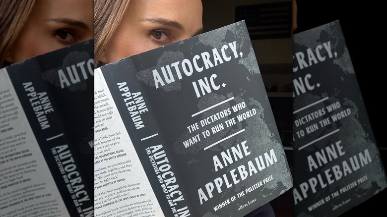 Natalie Portman partially hiding her face behind a book cover