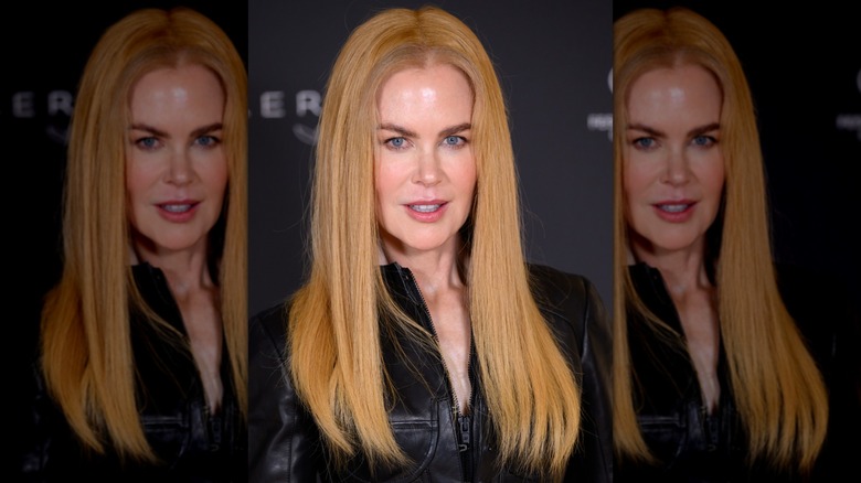 Nicole Kidman in a strawberry blond wig while wearing black