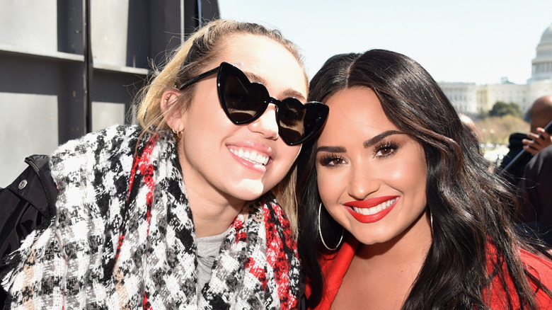 Miley Cyrus and Demi Lovato posing together.
