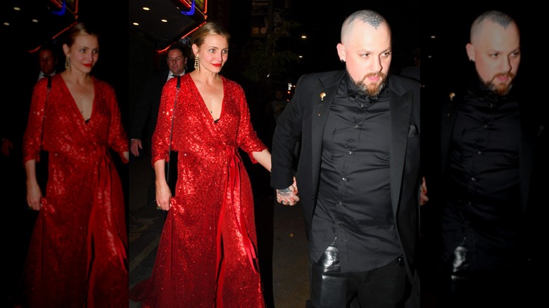 Cameron Diaz wearing a sparkly red dress while holding hands with Benji Madden dressed in black