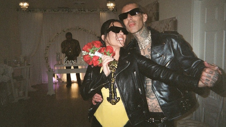 Kourtney Kardashian and Travis Barker posing in a Las Vegas chapel after getting married