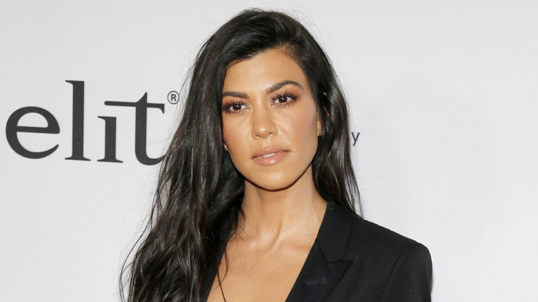 Kourtney Kardashian Barker photographed at a red carpet event wearing black.