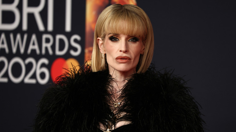 Kelly Osbourne posing in a black outfit