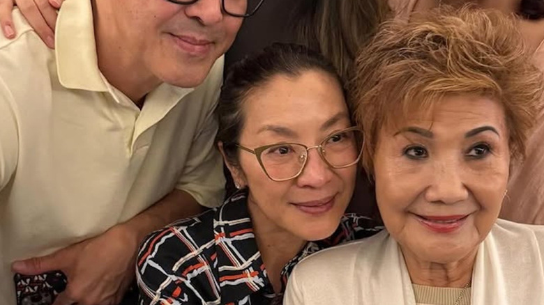 Michelle Yeoh posing for a group selfie without makeup