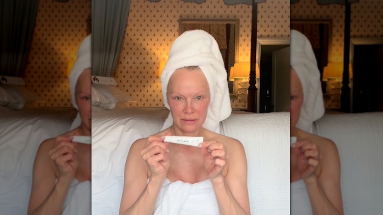 Pamela Anderson filming a makeup-free skincare video on Instagram