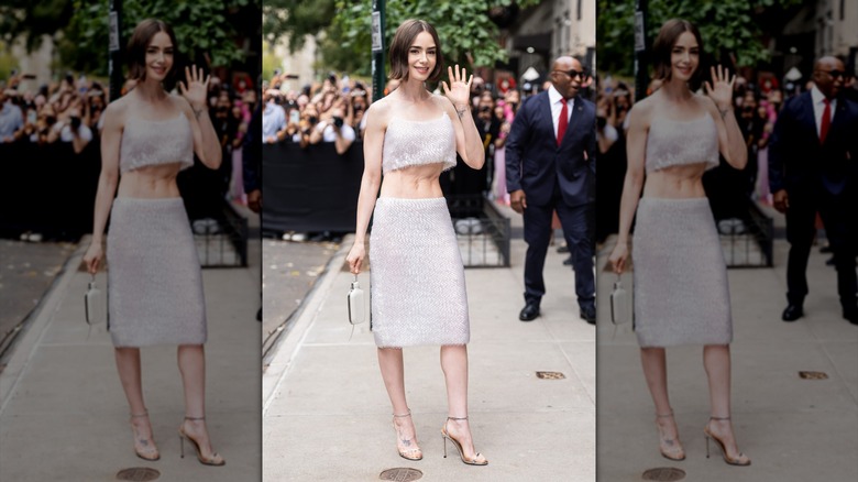 Lily Collins waving in a white sheer co-ord in New York City