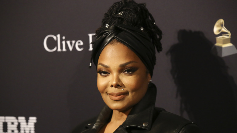 Janet Jackson at a red carpet event with a leather headband.