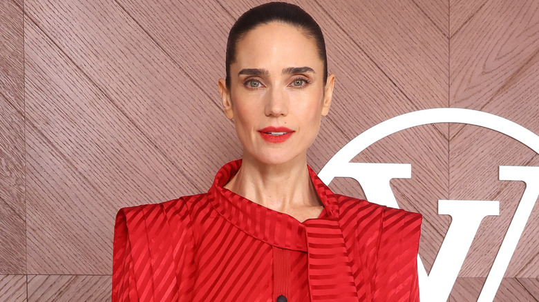 Jennifer Connelly at an industry event in a red outfit.