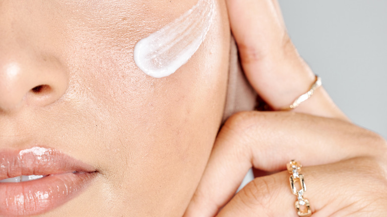 cream on woman's cheek