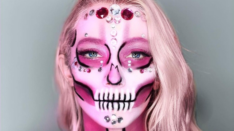 Girl with jewels around her skeleton makeup.