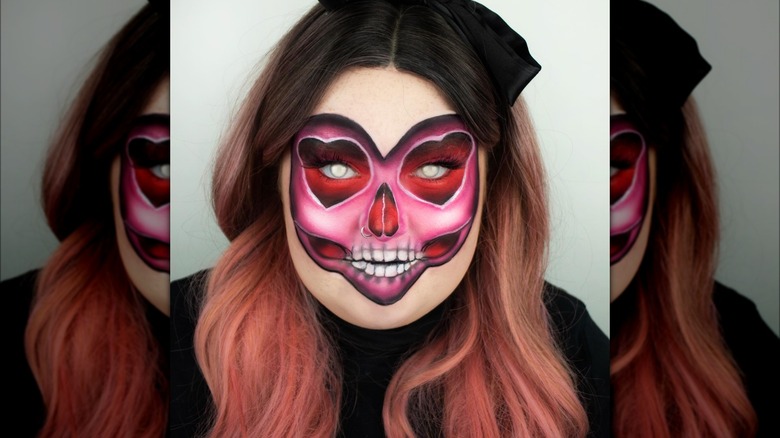 Girl wearing heart skeleton makeup.