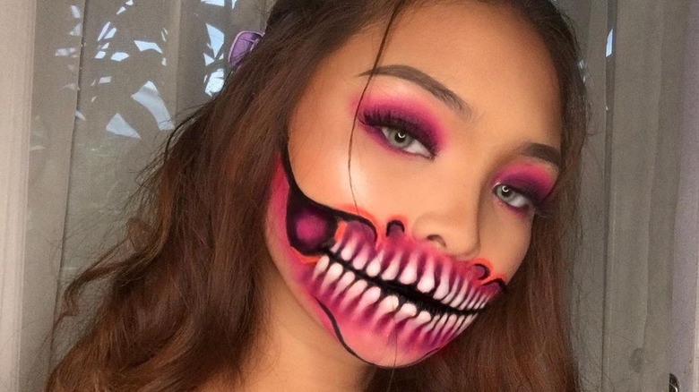 Girl with neon skeleton makeup.