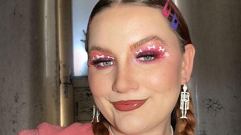 Girl with pink makeup with bone details.